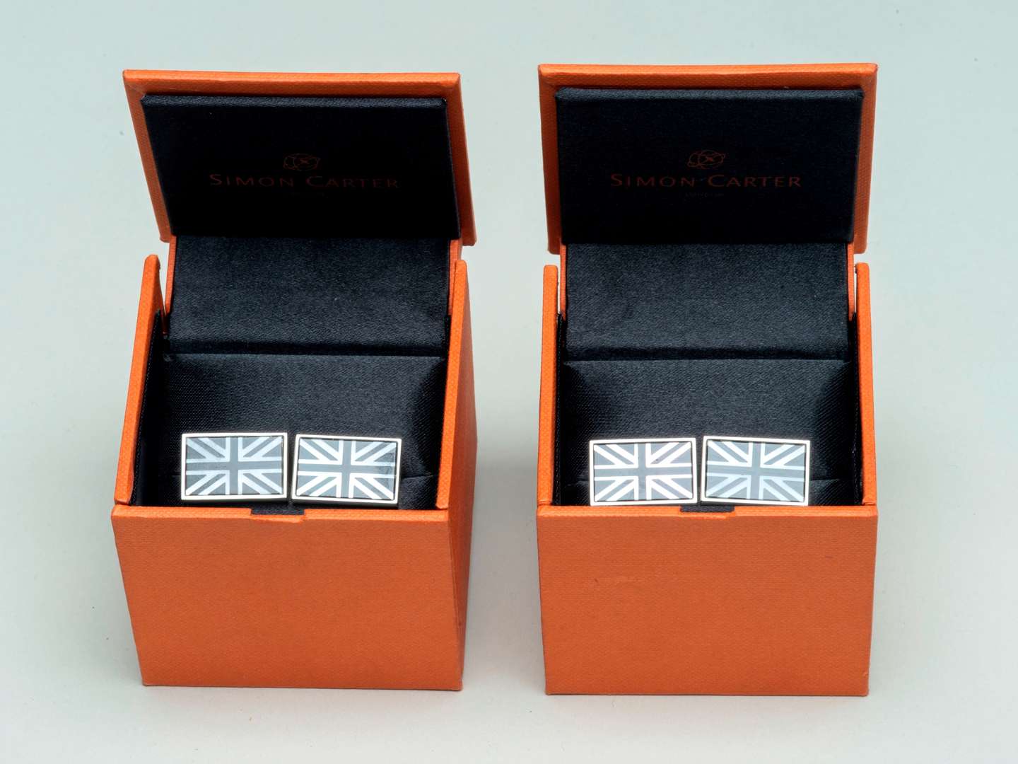 <p>Two pairs of Simon Carter Onyx and MOP Union Jack Cufflink</p>