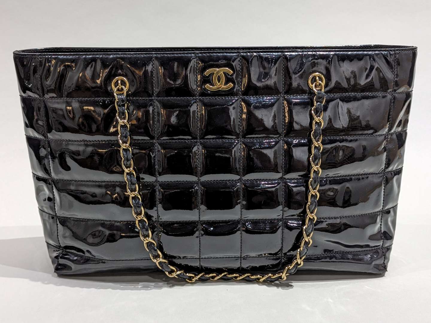 <p>Chanel vintage quilted patent chocolate bar tote</p>