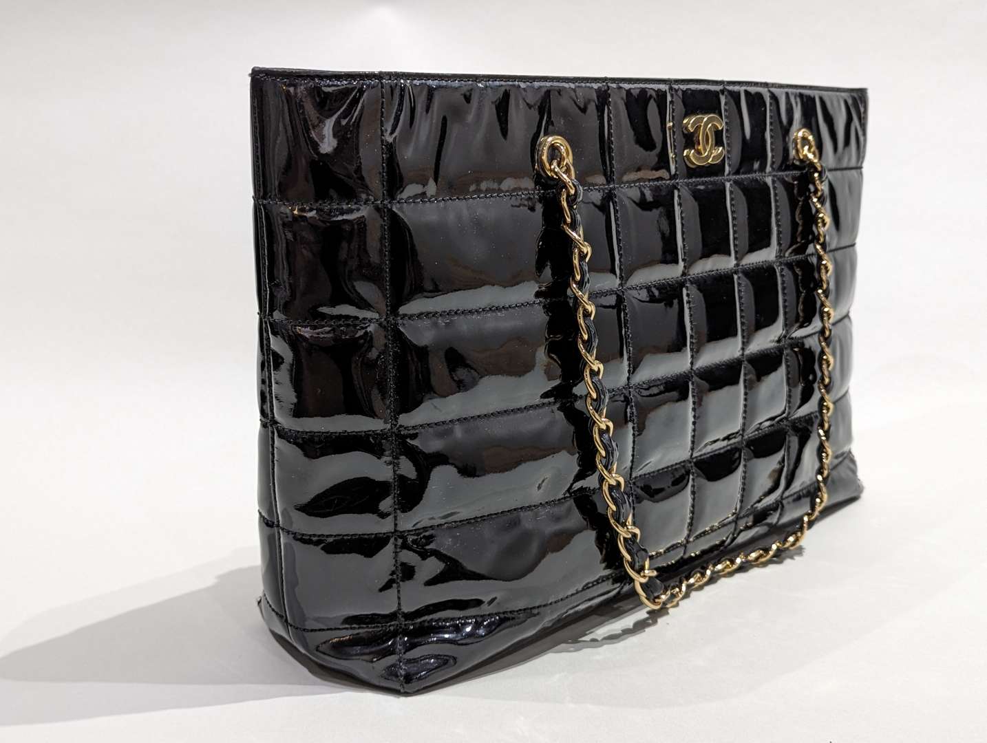 <p>Chanel vintage quilted patent chocolate bar tote</p>