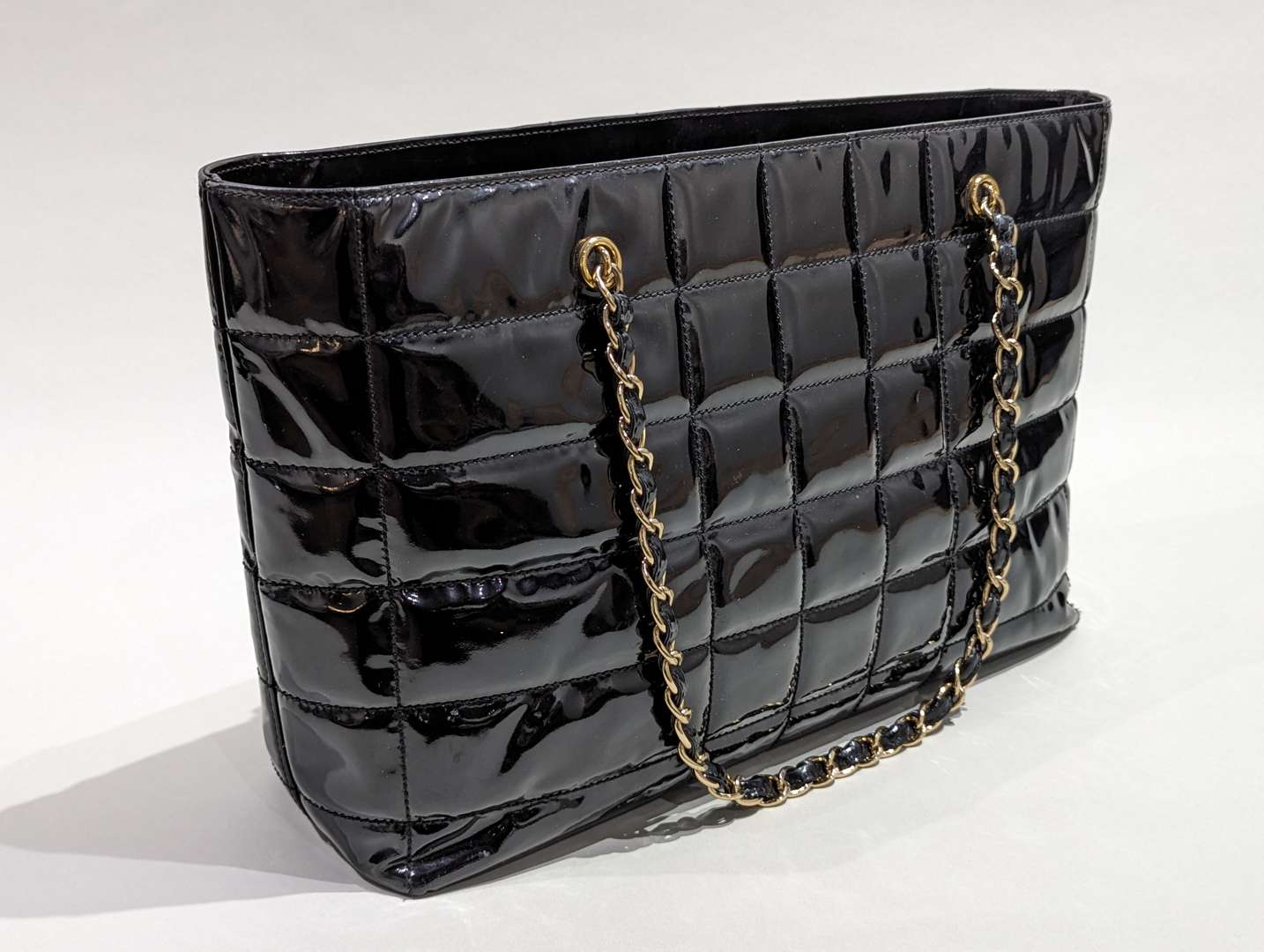 <p>Chanel vintage quilted patent chocolate bar tote</p>