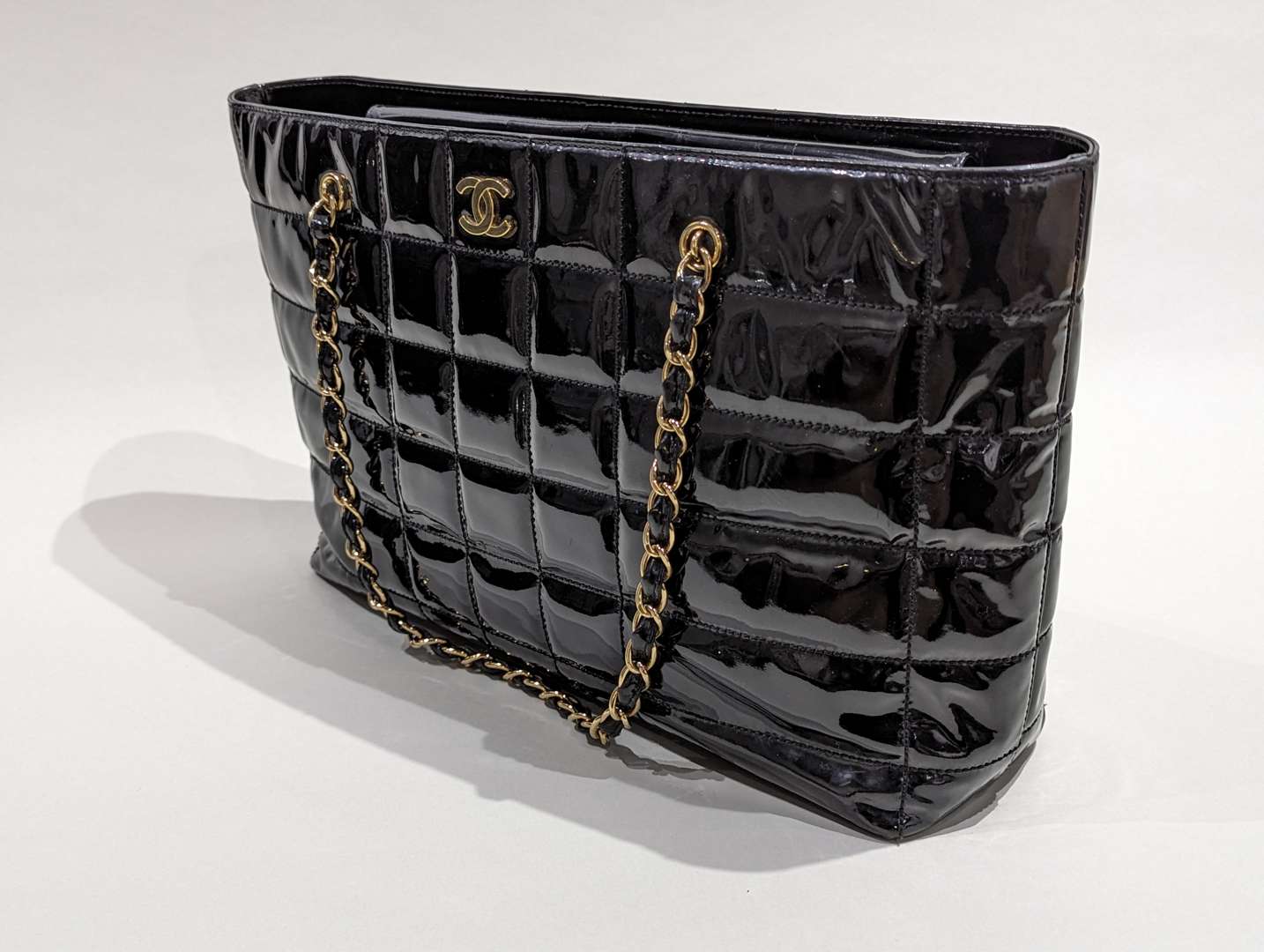 <p>Chanel vintage quilted patent chocolate bar tote</p>