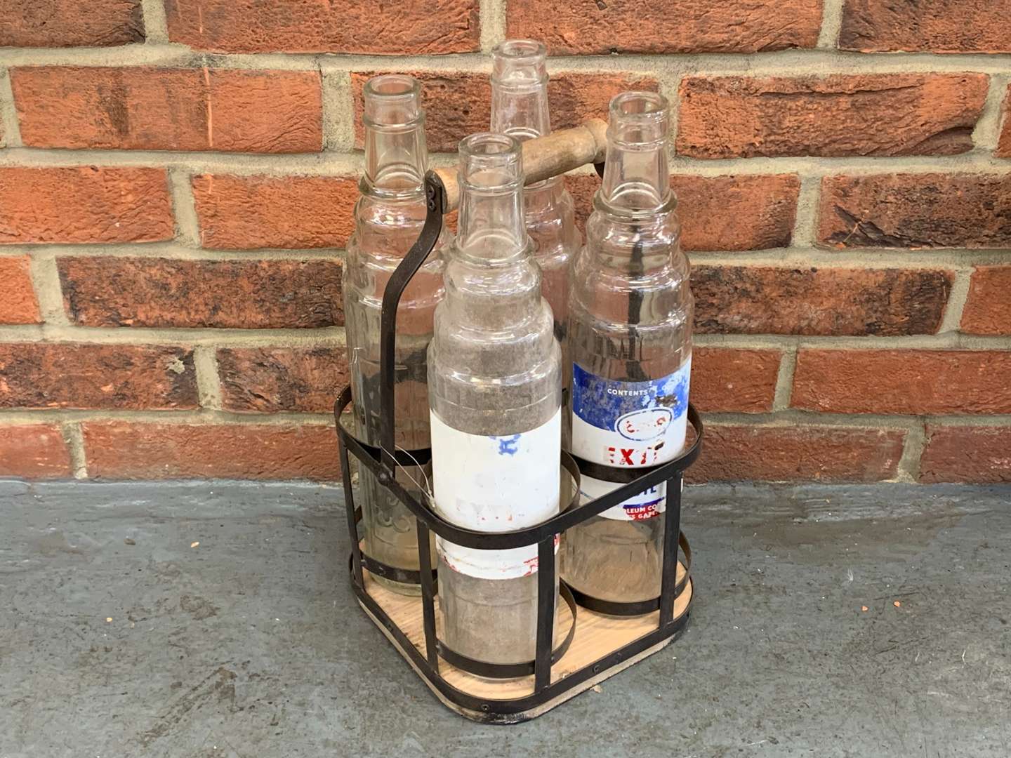 <p>Four Glass Esso Oil Bottles and Holder</p>