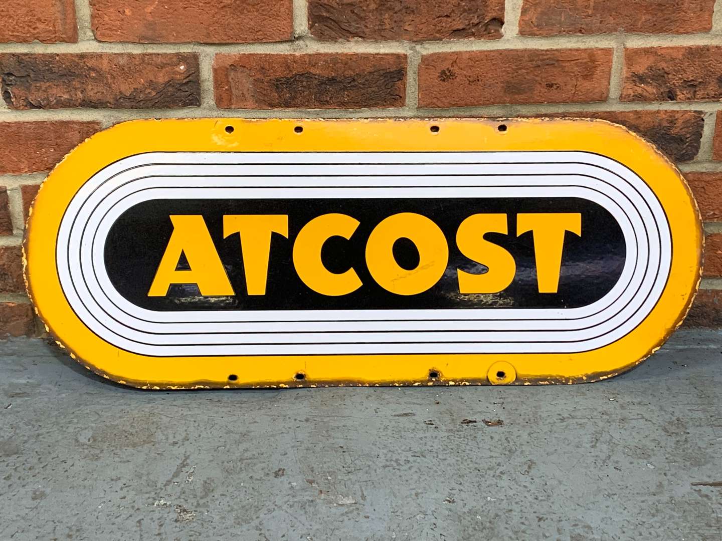 <p>Atcost Enamel Sign</p>