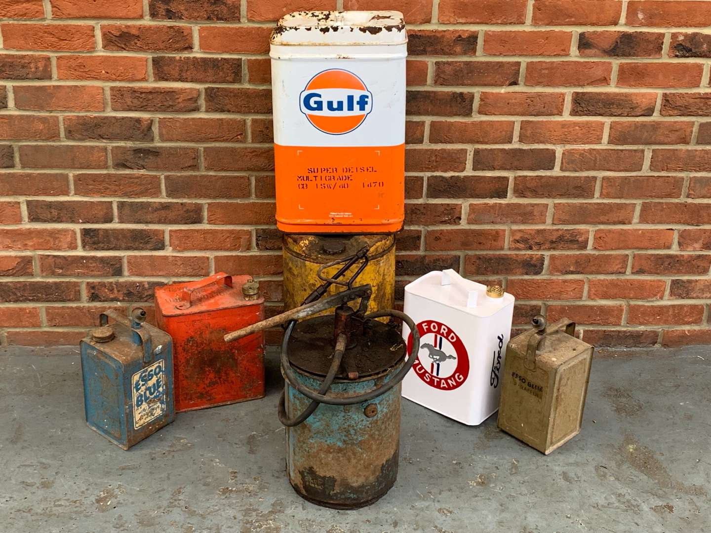 <p>Seven Mixed Grease and Fuel Cans</p>