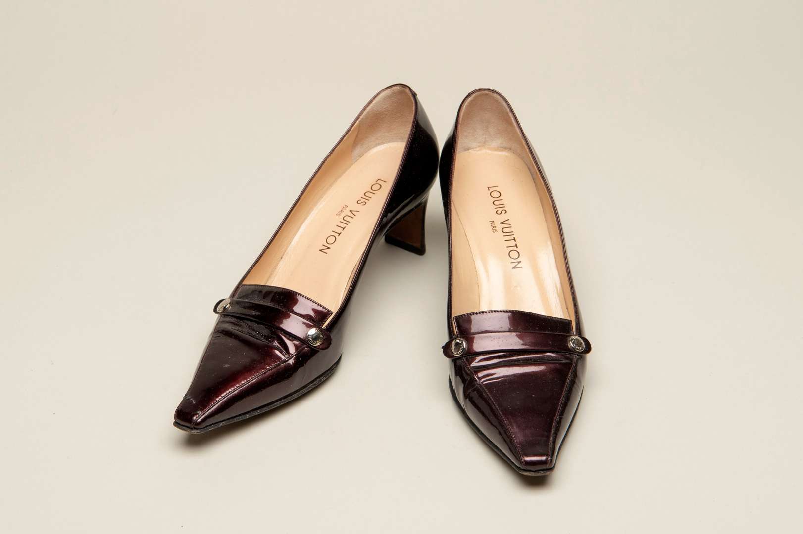 <p>LOUIS VUITTON, a pair of dark bronze, patent leather pumps</p>