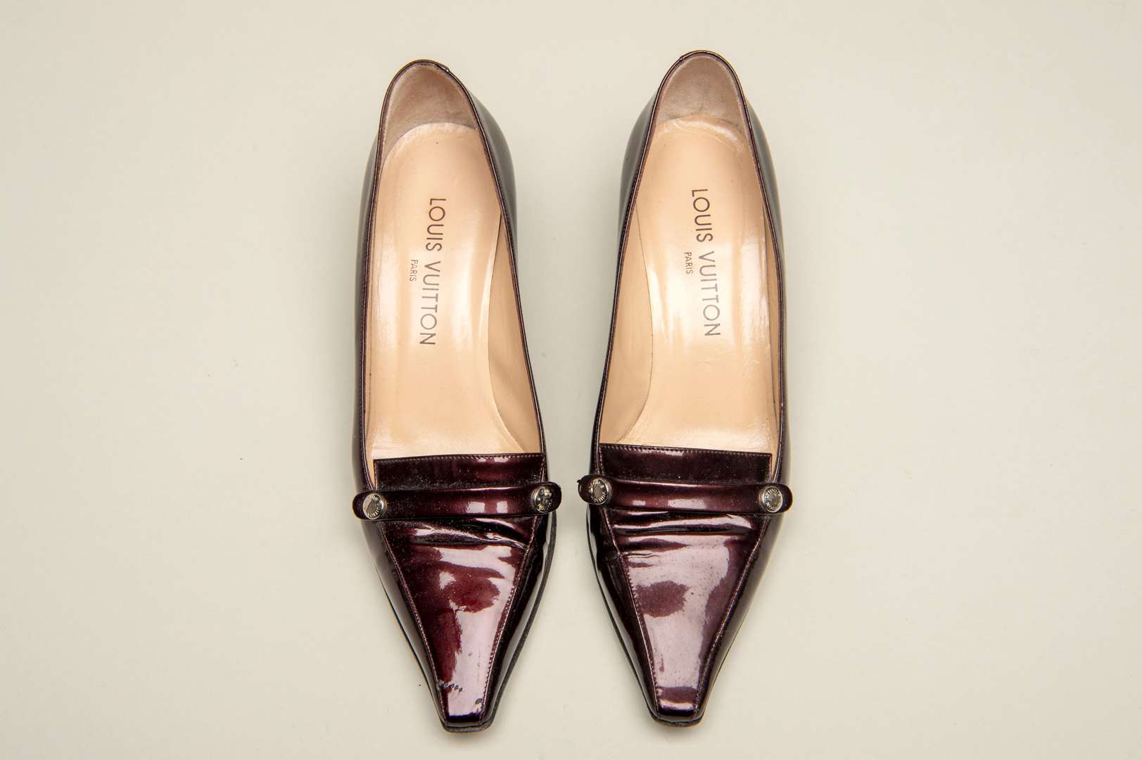 <p>LOUIS VUITTON, a pair of dark bronze, patent leather pumps</p>