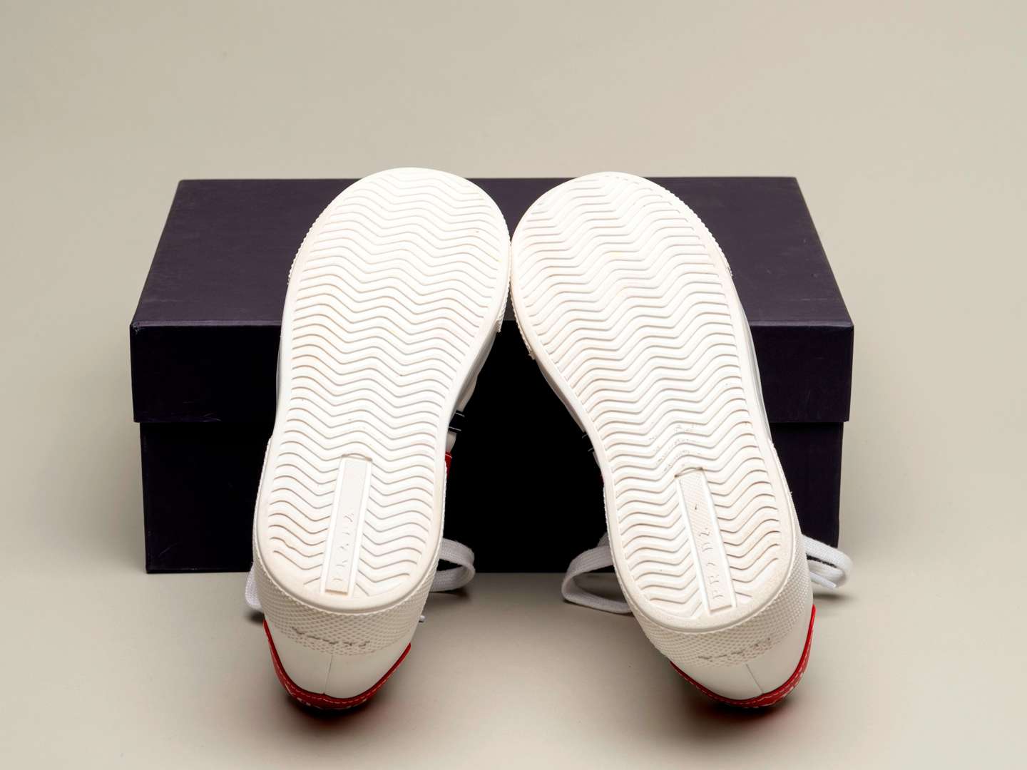 <p>PRADA, a pair of Bianco+ Rosso, Vitello Soft sneakers</p>