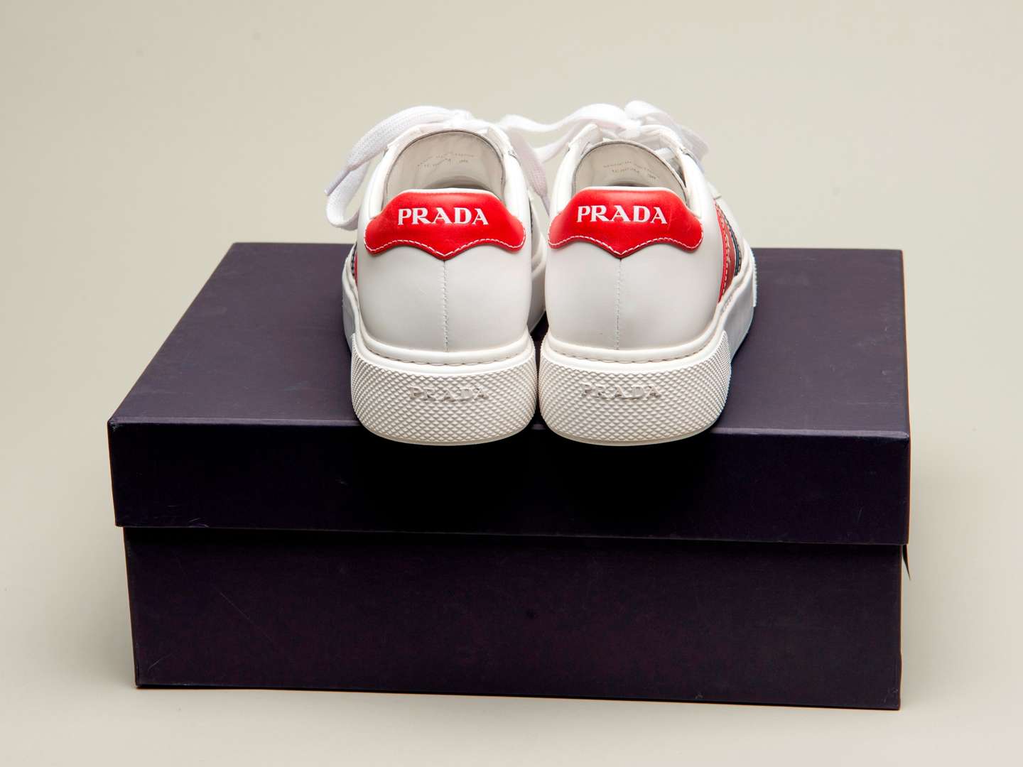 <p>PRADA, a pair of Bianco+ Rosso, Vitello Soft sneakers</p>