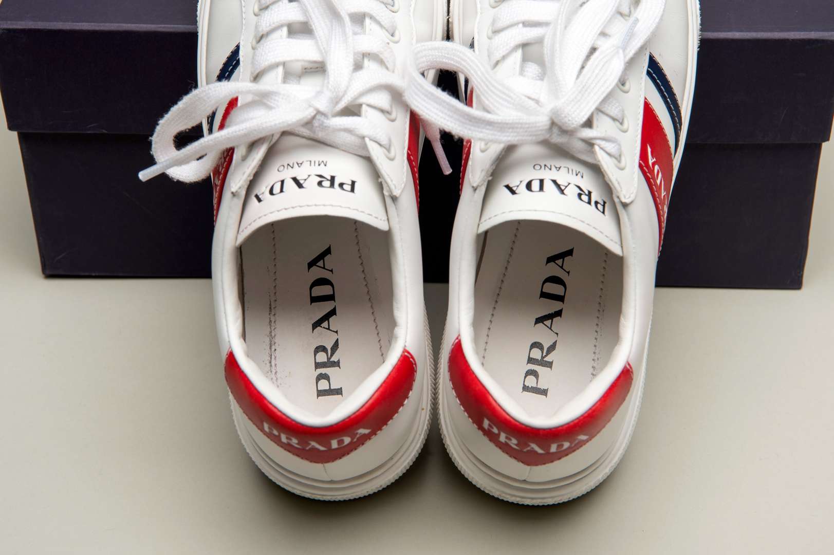 <p>PRADA, a pair of Bianco+ Rosso, Vitello Soft sneakers</p>