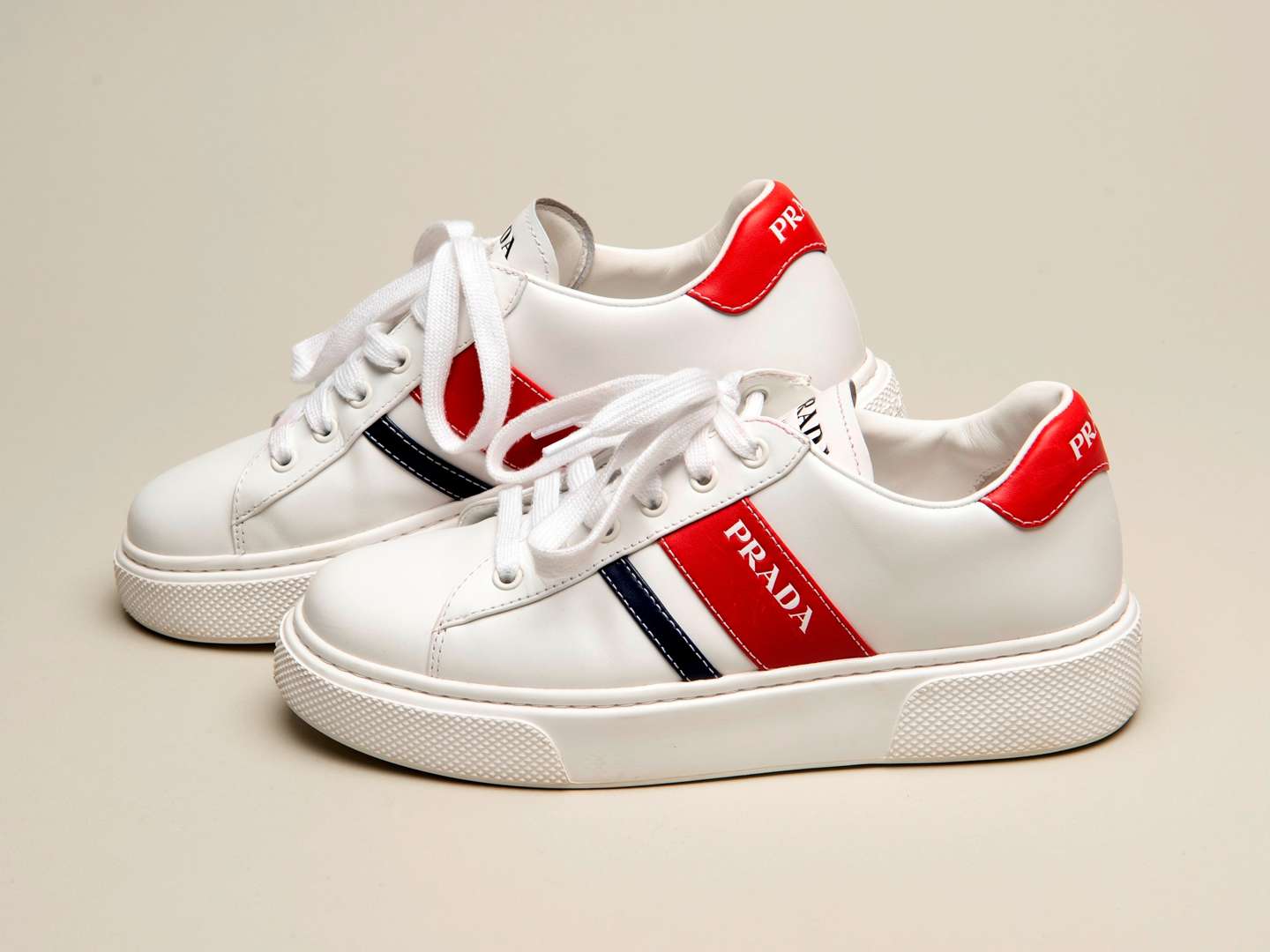 <p>PRADA, a pair of Bianco+ Rosso, Vitello Soft sneakers</p>