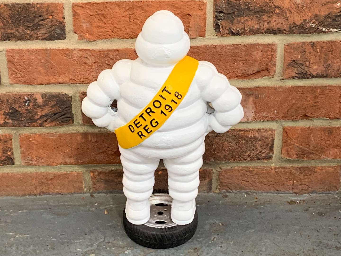 <p>Cast Iron Painted Michelin Man on A Tyre</p>