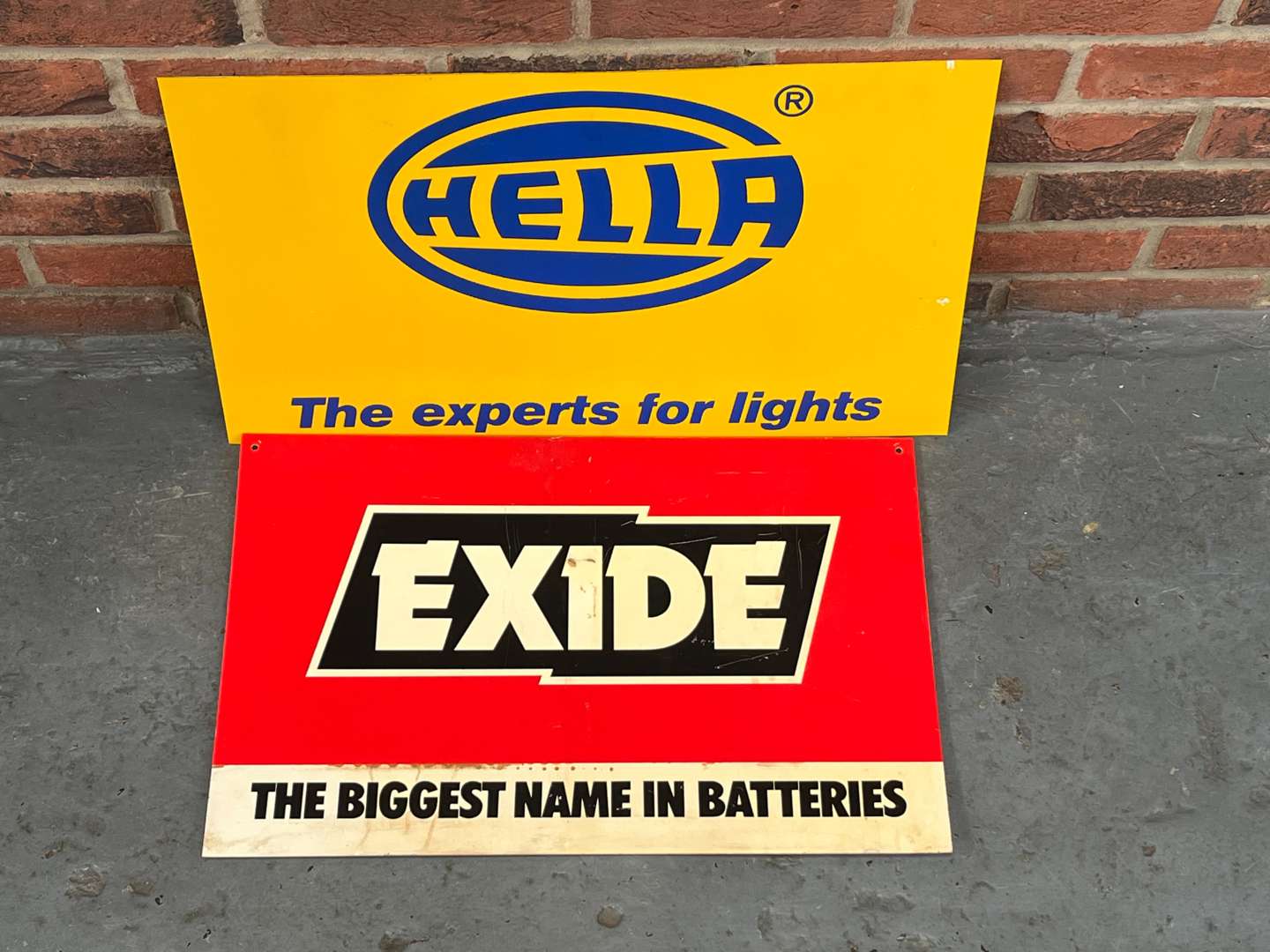 <p>Hella Lights and Exide Batteries Plastic Display Signs (2)</p>