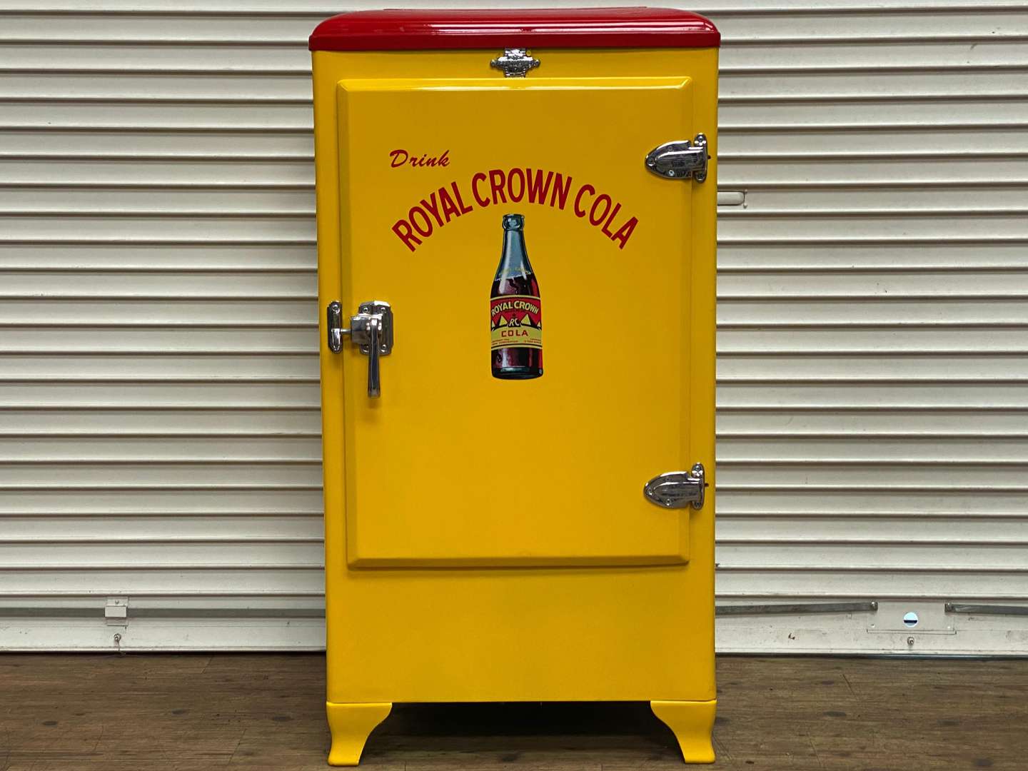 <p>FRIGIDAIRE, a 1940s American upright refrigerator, repainted in “Royal Crown Cola” livery</p>