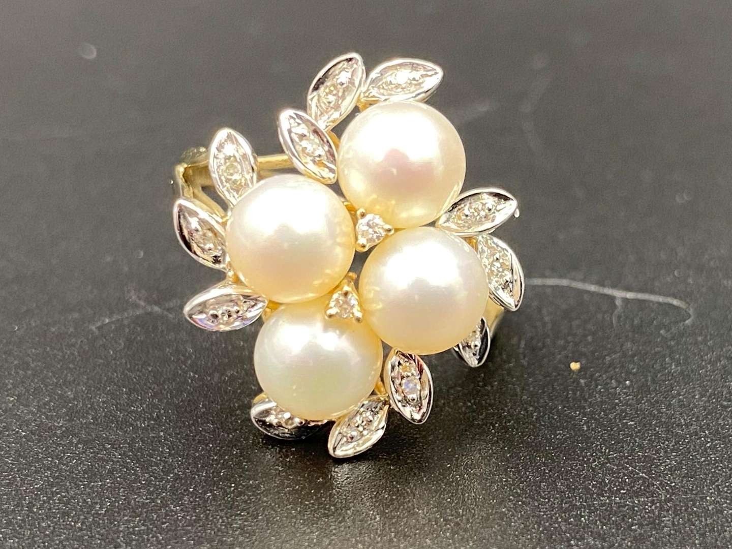 <p>A cultured pearl and diamond set, 9ct yellow and white gold, cluster ring</p>