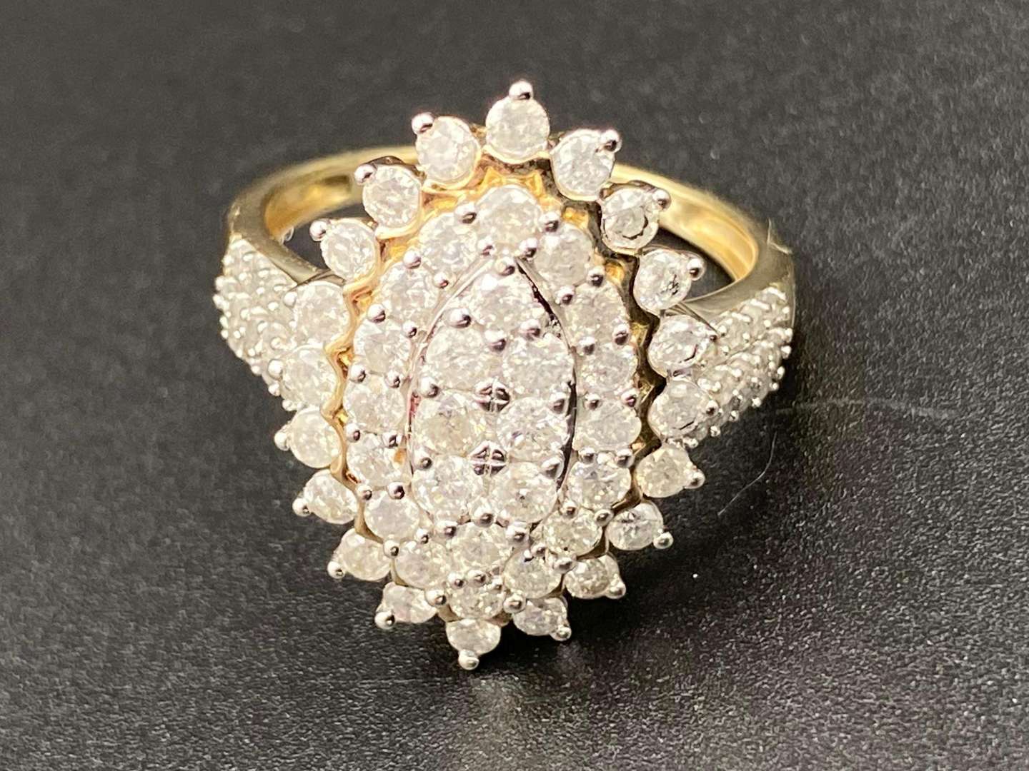 <p>A Marquise shaped, diamond set, 9ct yellow gold cluster ring.</p>