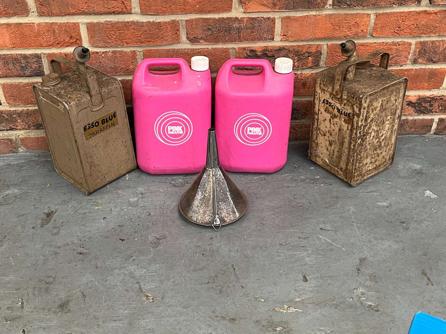 <p>Two Esso Paraffin Cans and Two Pink Paraffin Bottles&nbsp;</p>